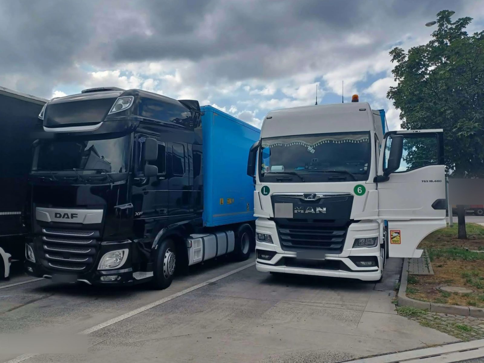Our DAF XF and MAN TGX tractor units in a parking lot
